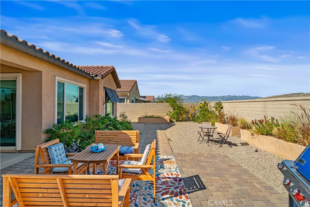 82 Prosecco Rancho Mirage, CA 92270 - Photo 32 of 56 a view of a patio with furniture and a lake view