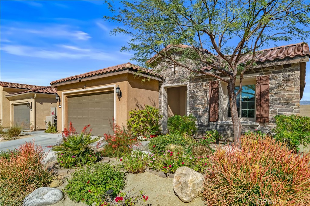 82 Prosecco Rancho Mirage, CA 92270 - Photo 4 of 56 a front view of a house with a yard