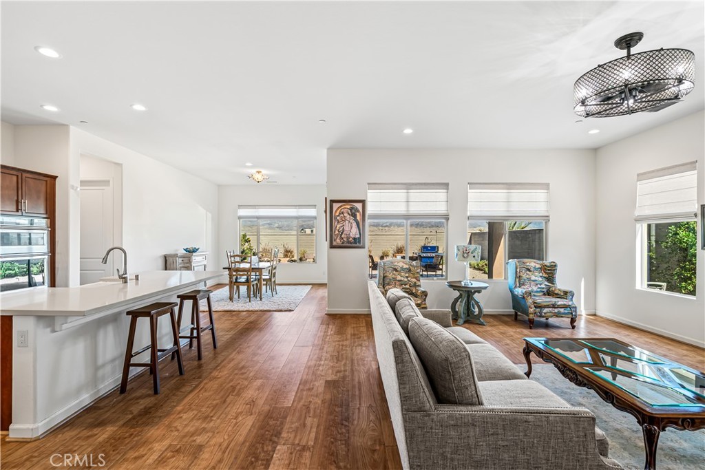 82 Prosecco Rancho Mirage, CA 92270 - Photo 6 of 56 a living room with furniture wooden floor and a large window
