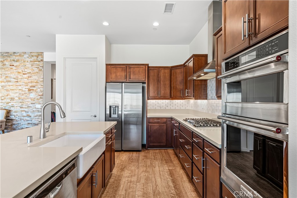 82 Prosecco Rancho Mirage, CA 92270 - Photo 7 of 56 a kitchen with stainless steel appliances a sink stove and refrigerator