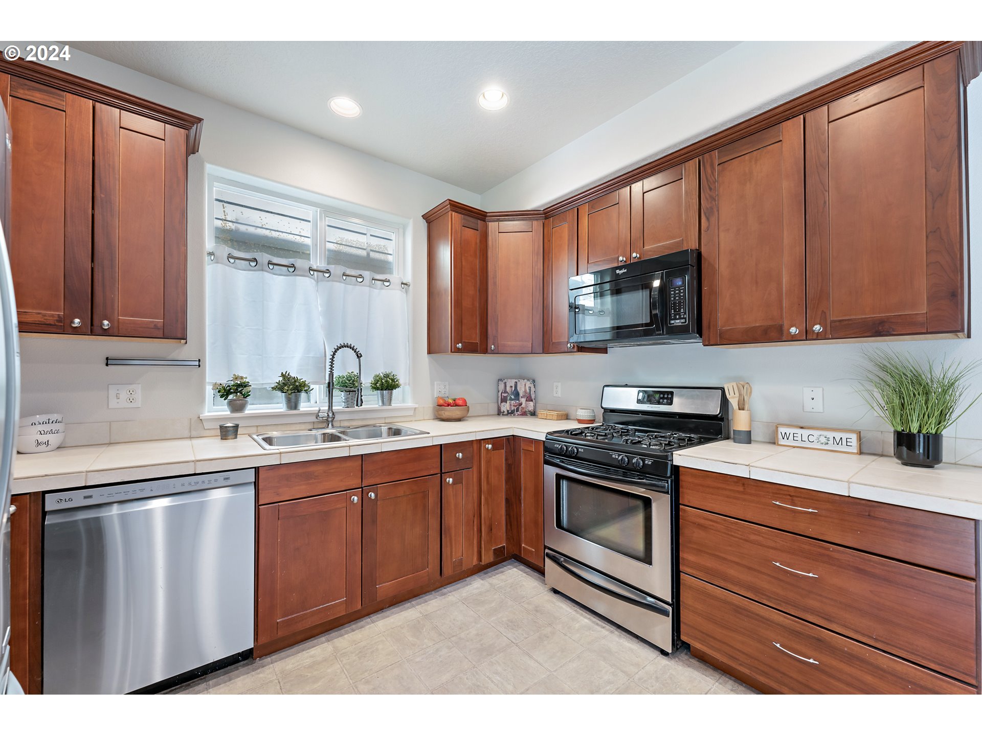 3149 Southwest 173rd Avenue Beaverton, OR 97003 - Photo 12 of 35 a kitchen with stainless steel appliances granite countertop a sink a stove and cabinets