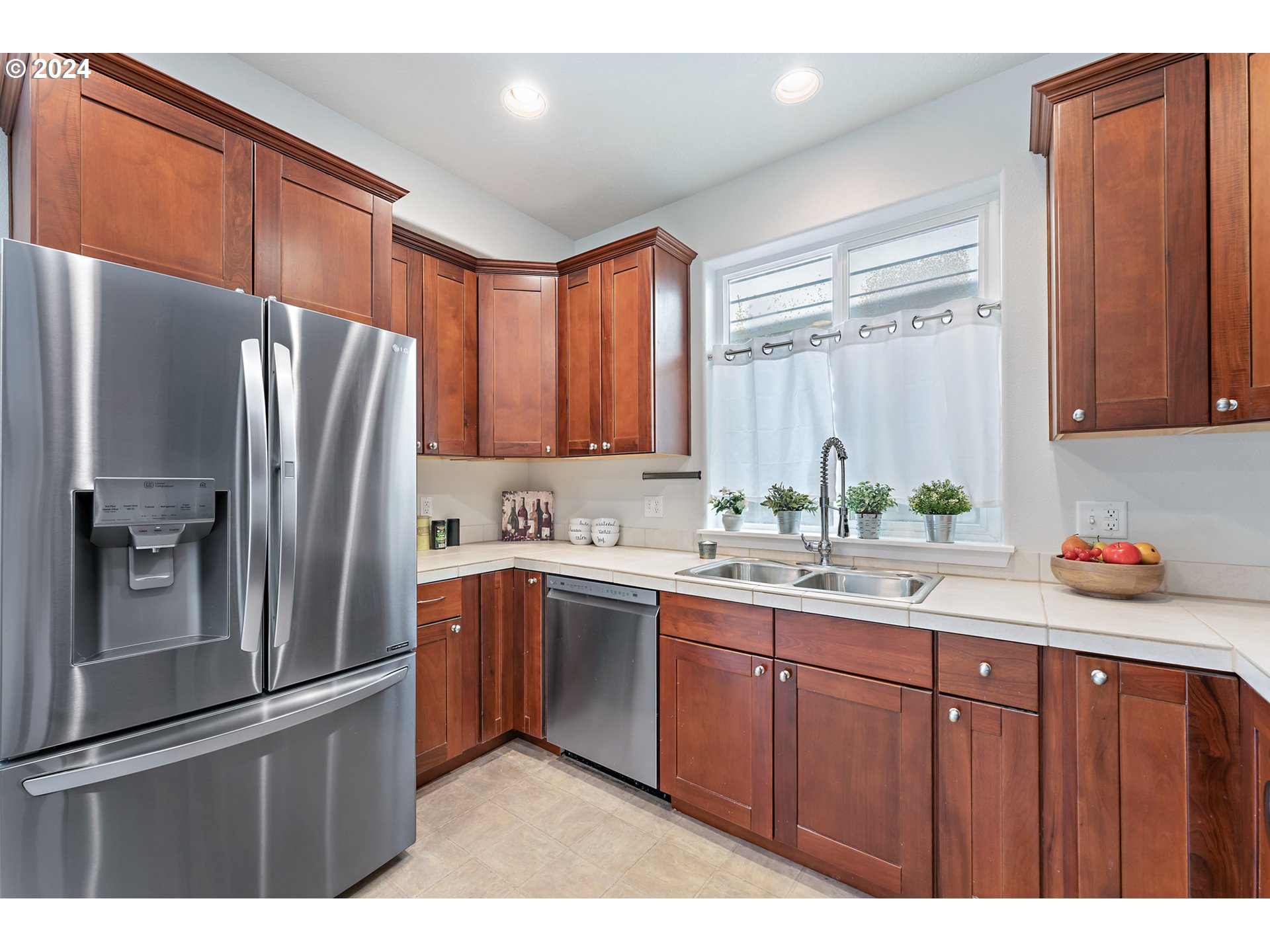 3149 Southwest 173rd Avenue Beaverton, OR 97003 - Photo 13 of 35 a kitchen with granite countertop stainless steel appliances a refrigerator and a sink
