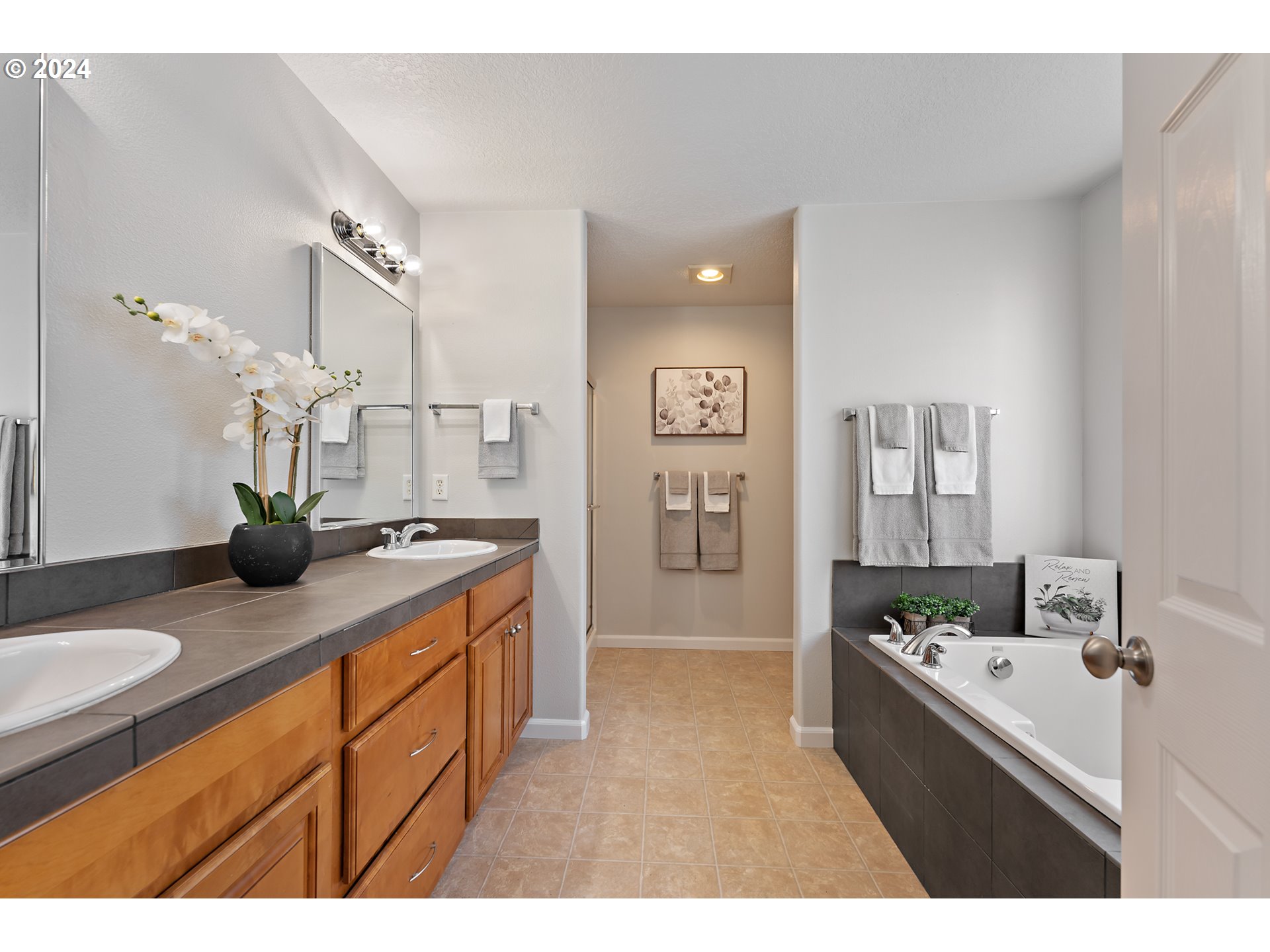 3149 Southwest 173rd Avenue Beaverton, OR 97003 - Photo 17 of 35 a bathroom with a granite countertop sink a mirror and a bathtub