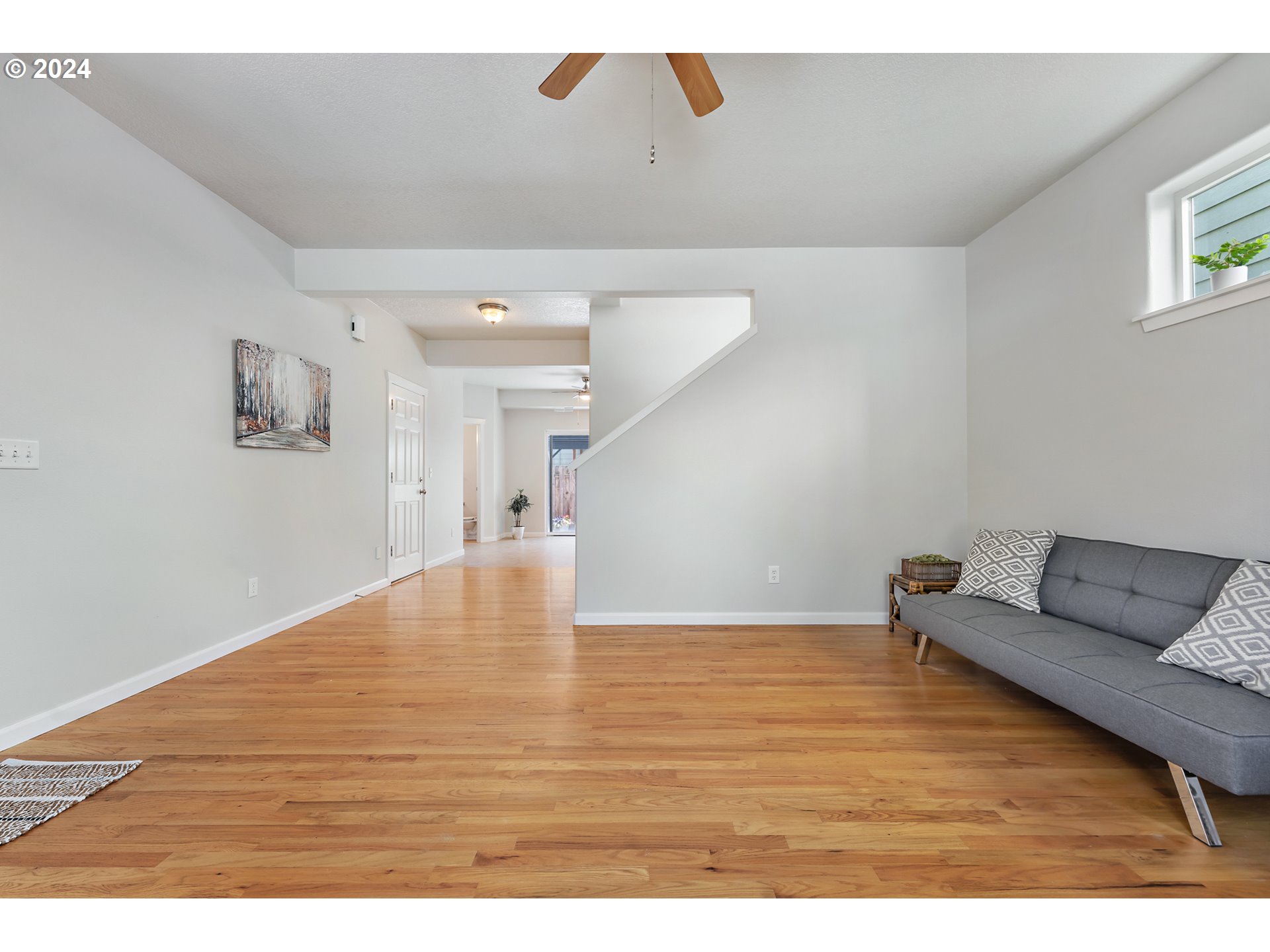 3149 Southwest 173rd Avenue Beaverton, OR 97003 - Photo 6 of 35 a view of an empty room with wooden floor and a window