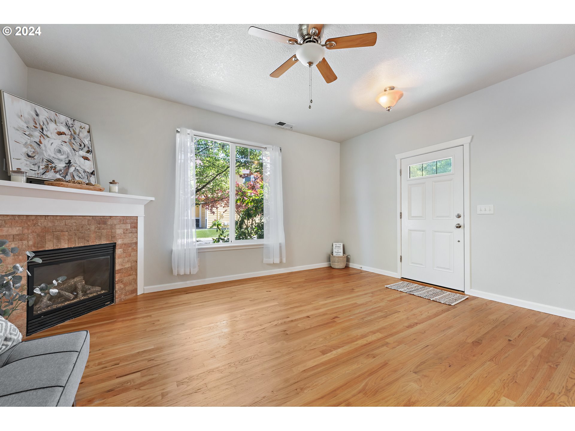 3149 Southwest 173rd Avenue Beaverton, OR 97003 - Photo 7 of 35 a view of empty room with wooden floor and fireplace