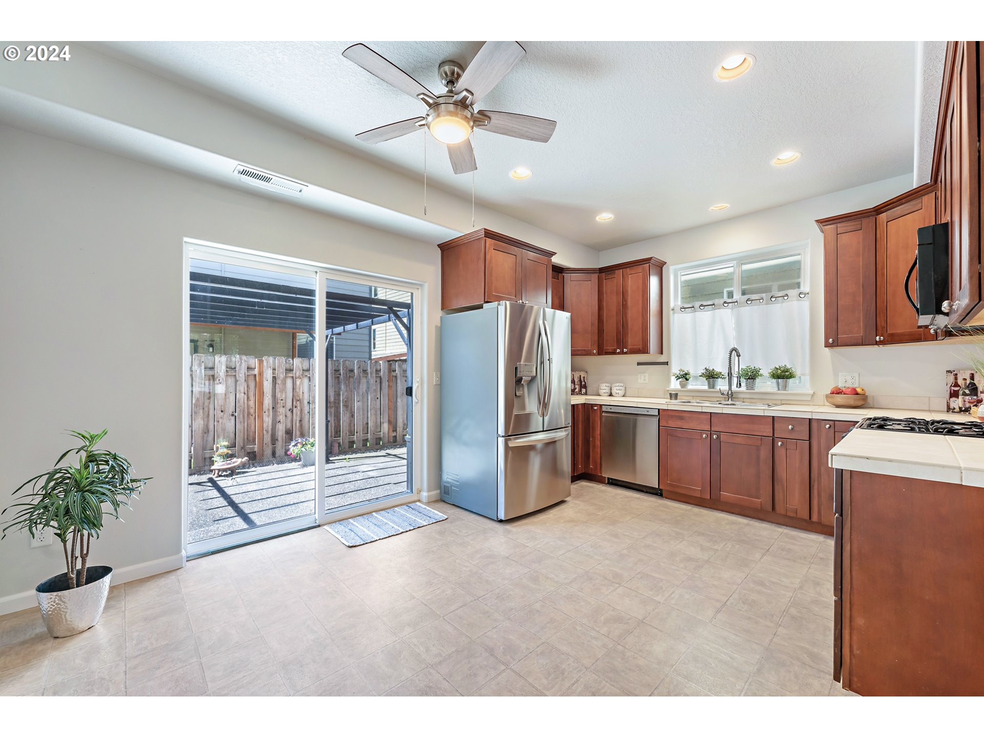 3149 Southwest 173rd Avenue Beaverton, OR 97003 - Photo 8 of 35 a kitchen with refrigerator and cabinets