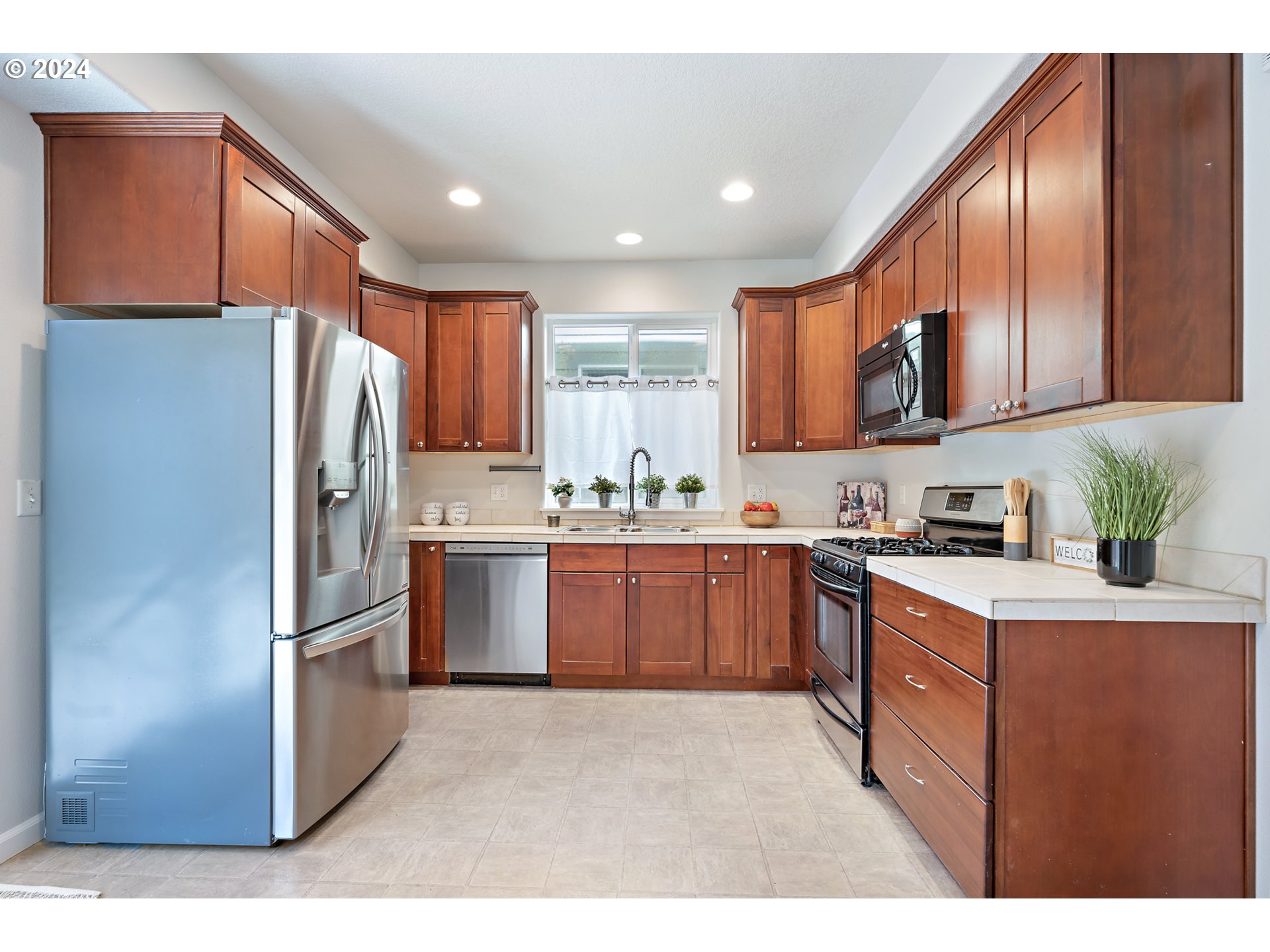 3149 Southwest 173rd Avenue Beaverton, OR 97003 - Photo 10 of 35 a kitchen with stainless steel appliances granite countertop a refrigerator sink and stove
