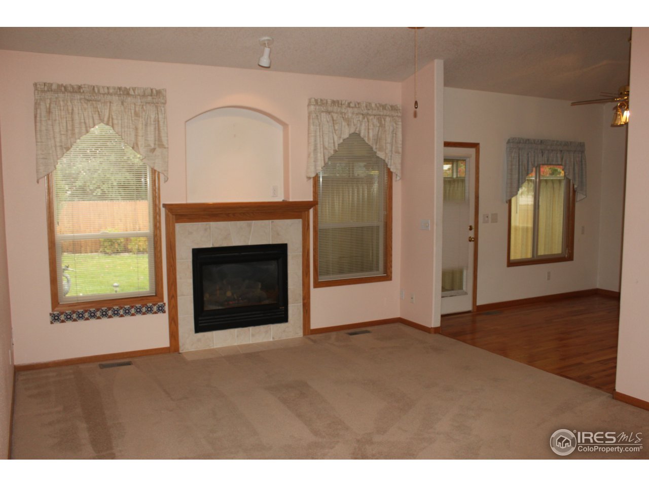 245 Sequoia Circle Windsor, CO 80550 - Photo 2 of 15 a view of an empty room with a fireplace and a window