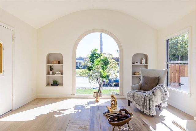 a living room with furniture and a potted plant