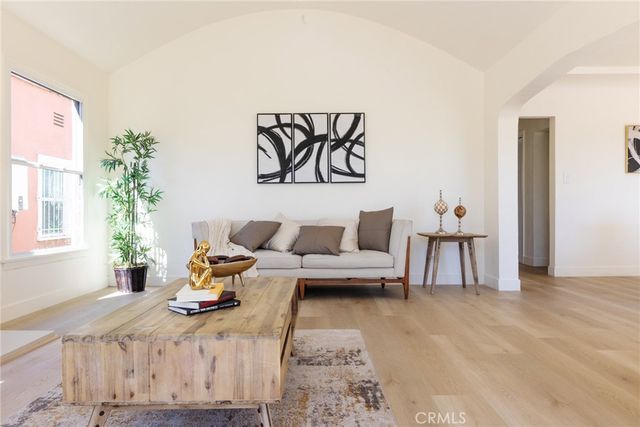 a living room with furniture and a potted plant