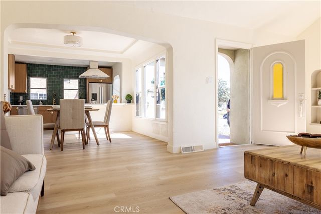 a view of a livingroom with furniture window and wooden floor