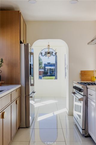 a hallway with a stove top oven and cabinets