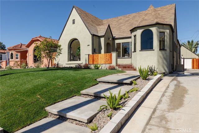 a front view of a house with garden