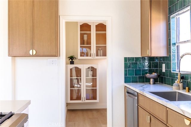 a view of a window and a potted plant on the wooden floor