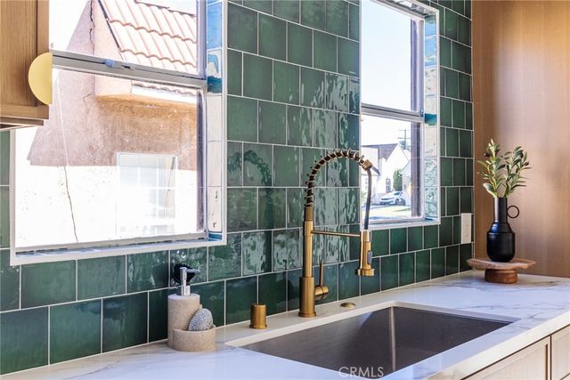 a stove top oven sitting inside of a kitchen