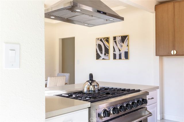 a stove top oven sitting inside of a kitchen