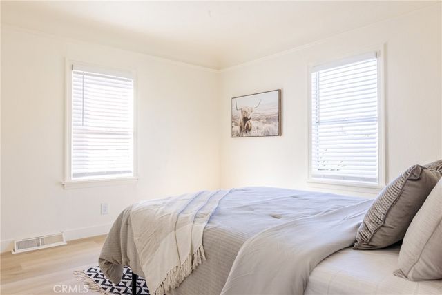 a large bed sitting in a bedroom next to a window