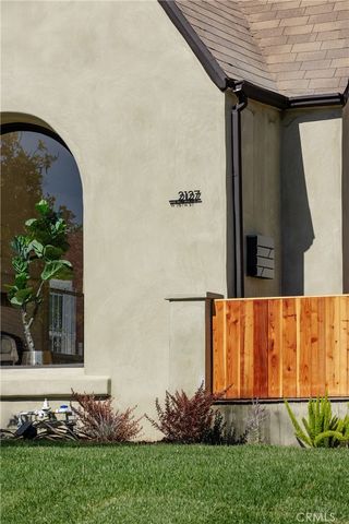 a view of a backyard with potted plants