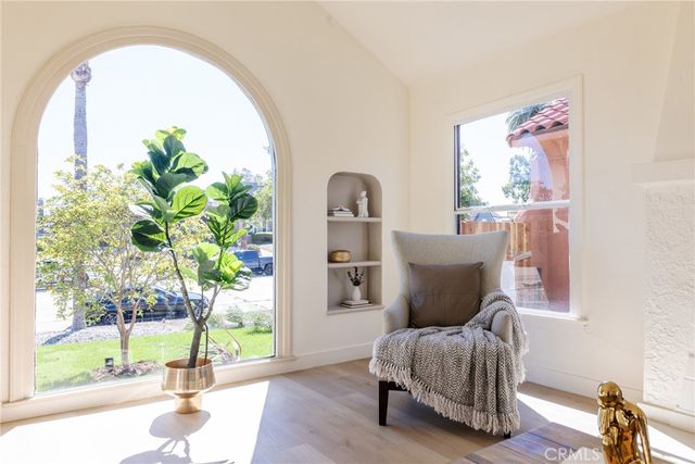 a living room with furniture and a floor to ceiling window