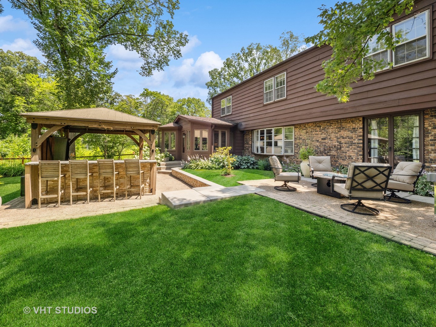 940 Shermer Road Northbrook, IL 60062 - Photo 19 of 41 a view of a patio with table and chairs under an umbrella
