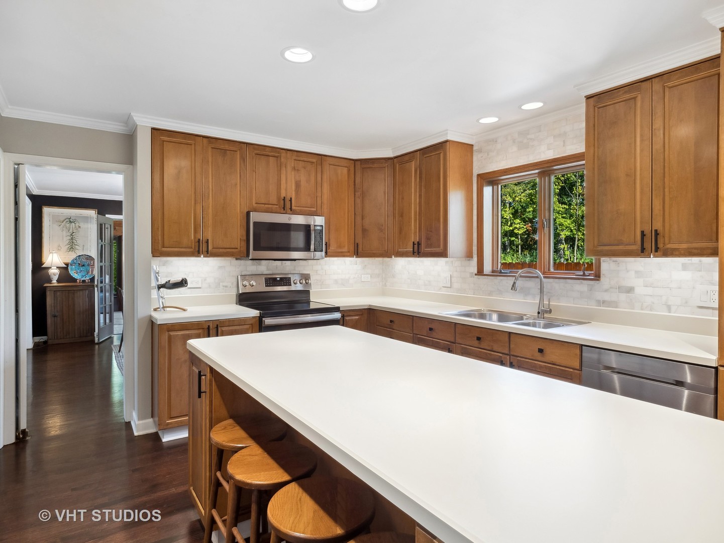 940 Shermer Road Northbrook, IL 60062 - Photo 25 of 41 a kitchen with a sink a stove a microwave and cabinets