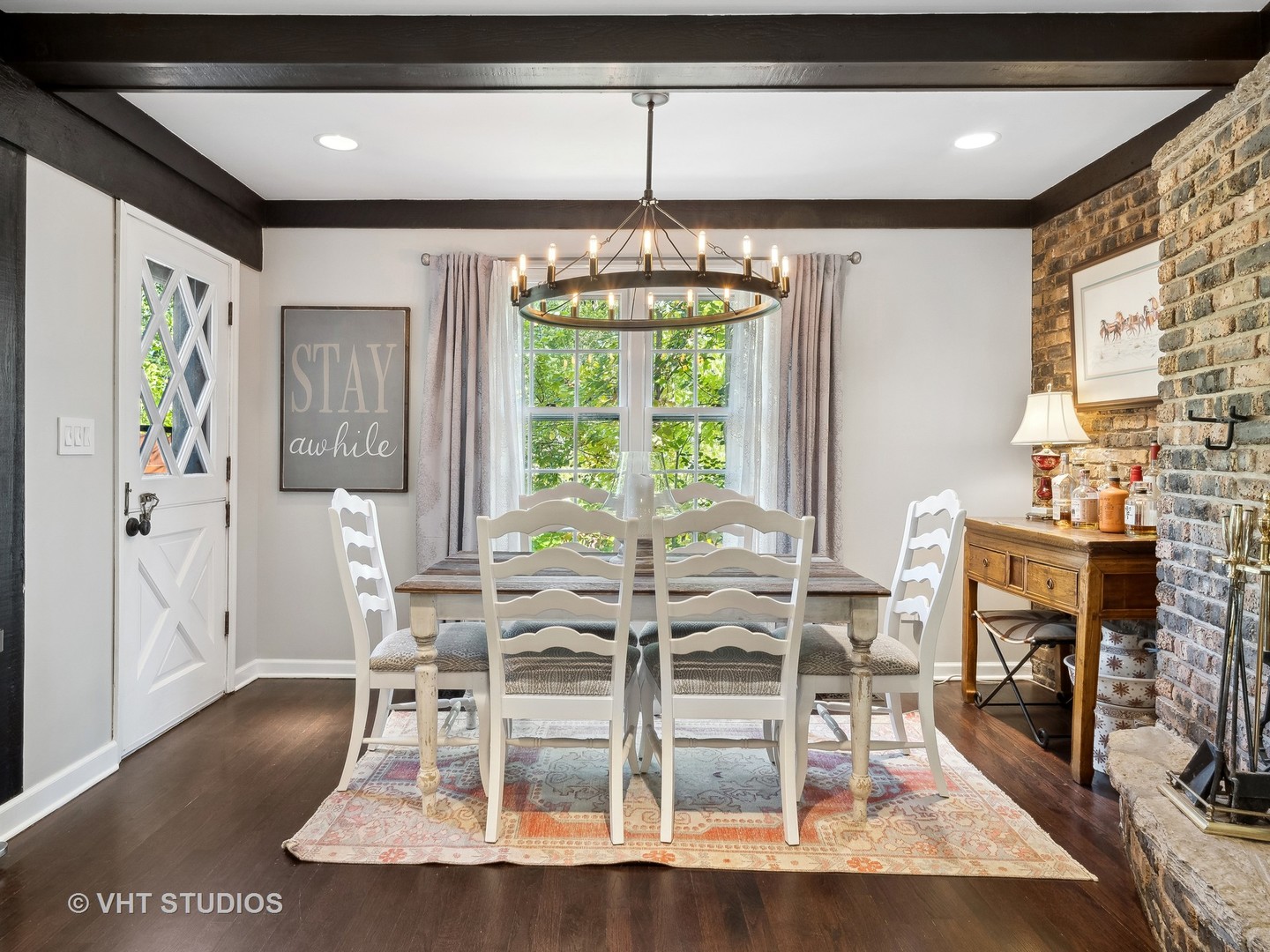 940 Shermer Road Northbrook, IL 60062 - Photo 35 of 41 a dining room with wooden floor a chandelier a glass table and chairs