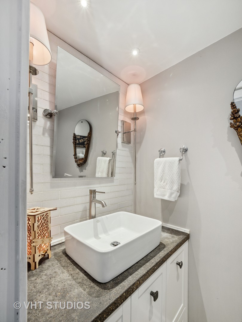 940 Shermer Road Northbrook, IL 60062 - Photo 4 of 41 a bathroom with a sink and a mirror