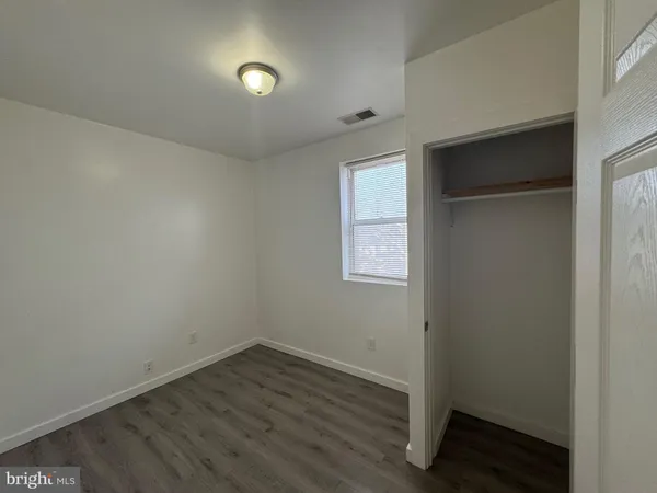 a bathroom with a bathtub shower sink mirror vanity and toilet
