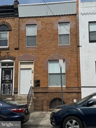 a front view of a house with parking space