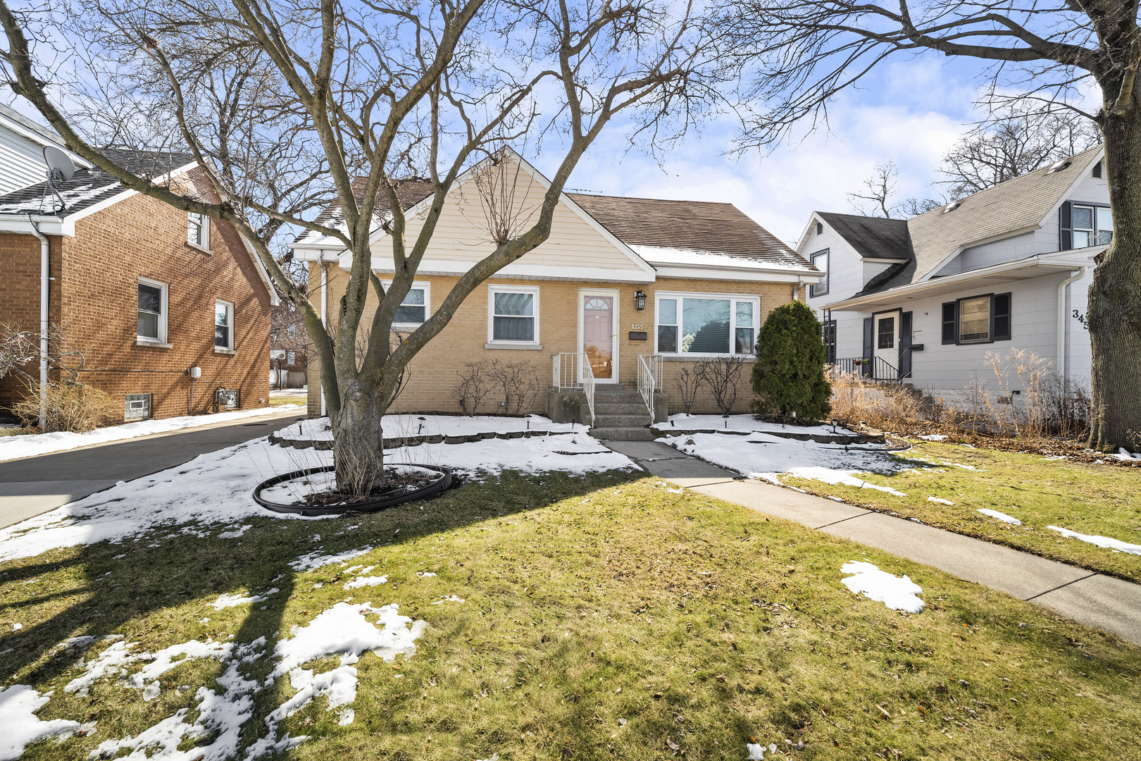 349 East Quincy Street Riverside, IL 60546 - Photo 2 of 26 a front view of a house with a yard