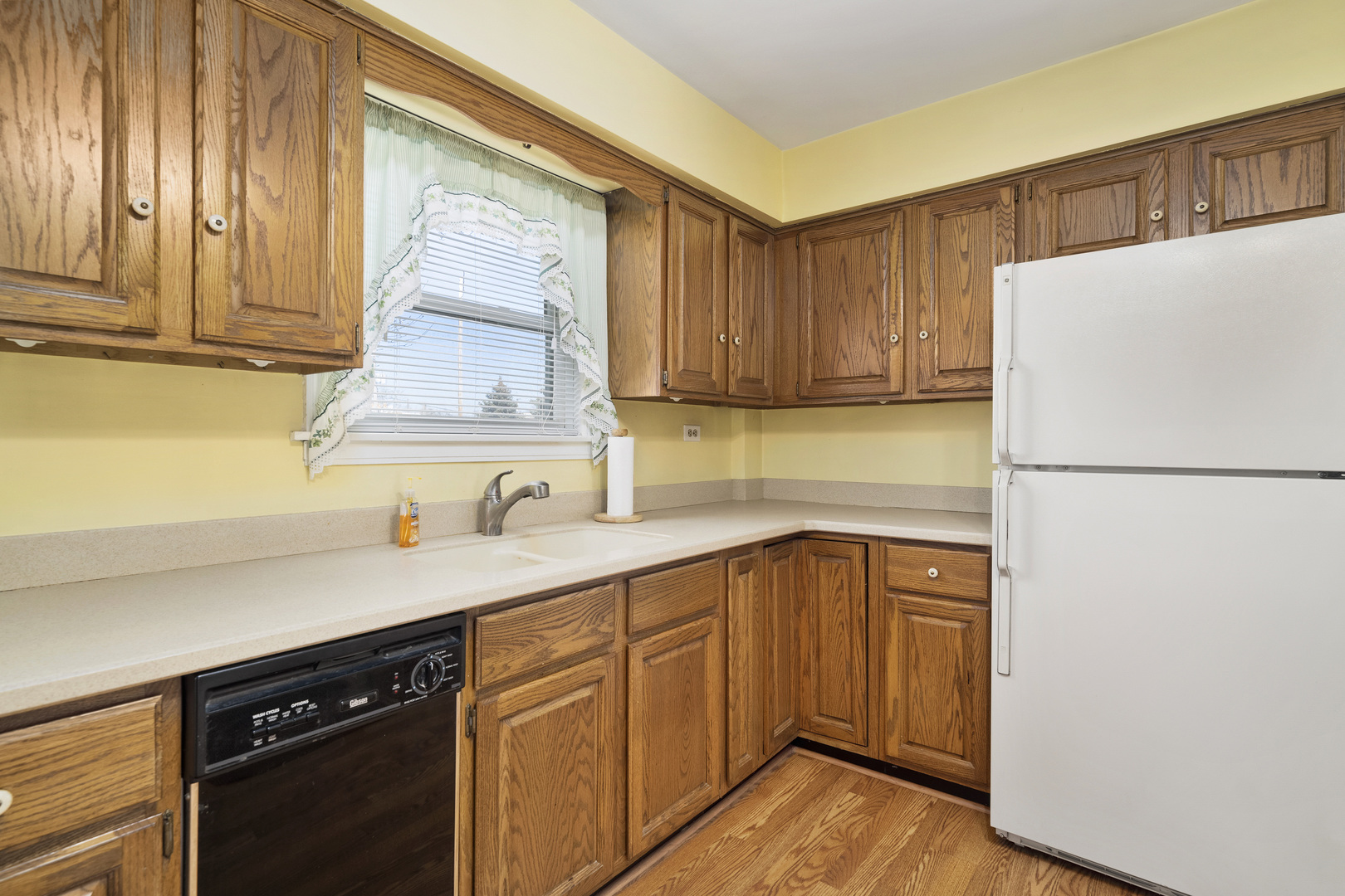 349 East Quincy Street Riverside, IL 60546 - Photo 8 of 26 a kitchen with a sink a refrigerator and cabinets