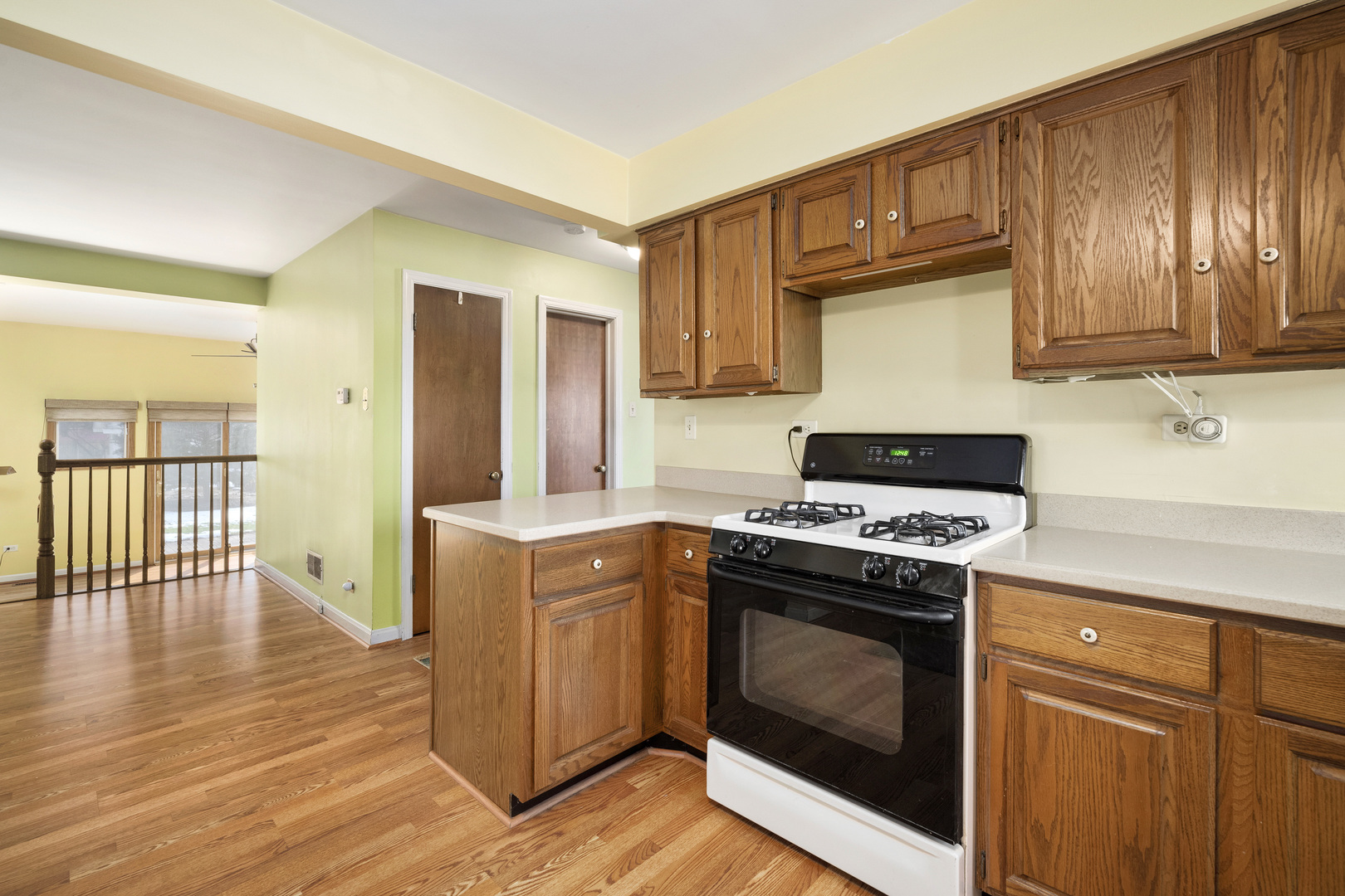 349 East Quincy Street Riverside, IL 60546 - Photo 10 of 26 a kitchen with granite countertop wooden floors and stainless steel appliances