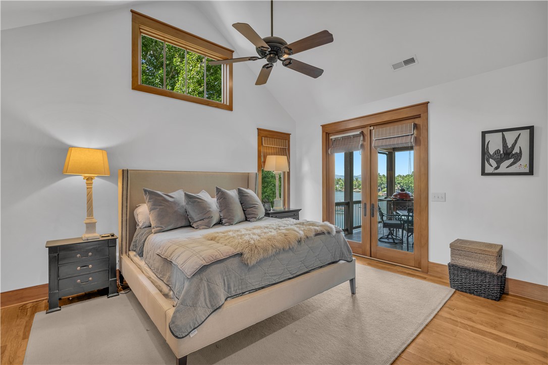 256 Talton Road Six Mile, SC 29682 - Photo 26 of 50 Warm wood trim frames the windows and glass doors of this light-filled bedroom.