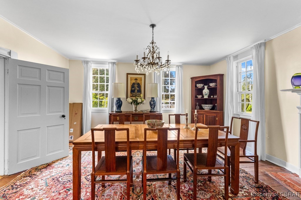 1701 Balls Neck Road Kilmarnock, VA 22482 - Photo 28 of 50 Dining space featuring crown molding and a notable chandelier