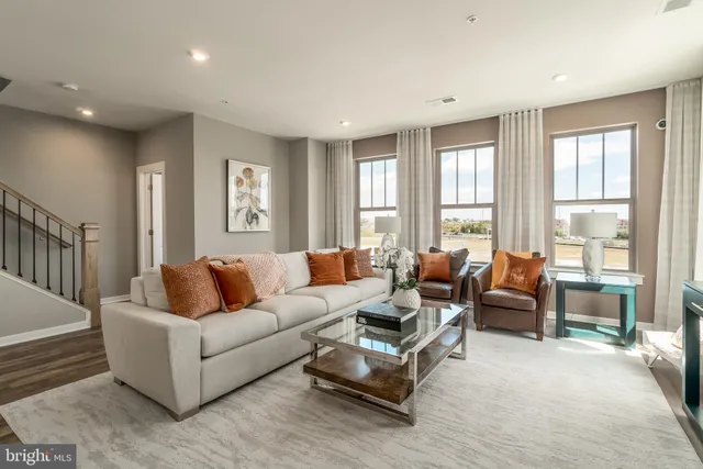 a living room with furniture and large windows