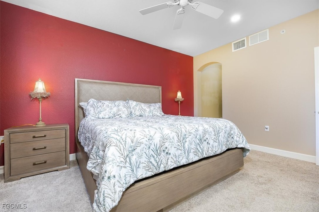 13091 Pebblebrook Ridge Court, Unit 101 Fort Myers, FL 33905 - Photo 17 of 39 a bed room with a bed and a lamp