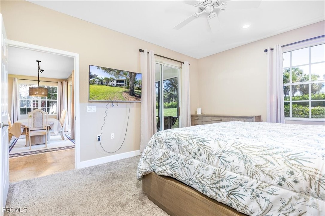 13091 Pebblebrook Ridge Court, Unit 101 Fort Myers, FL 33905 - Photo 18 of 39 a bedroom with a bed dresser and a large window