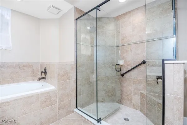 a bathroom with a shower and a sink