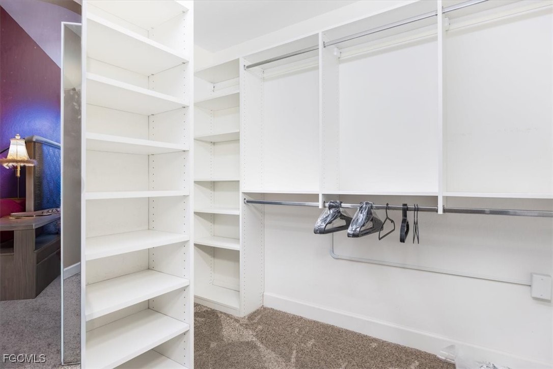 13091 Pebblebrook Ridge Court, Unit 101 Fort Myers, FL 33905 - Photo 22 of 39 a view of walk in closet with empty racks