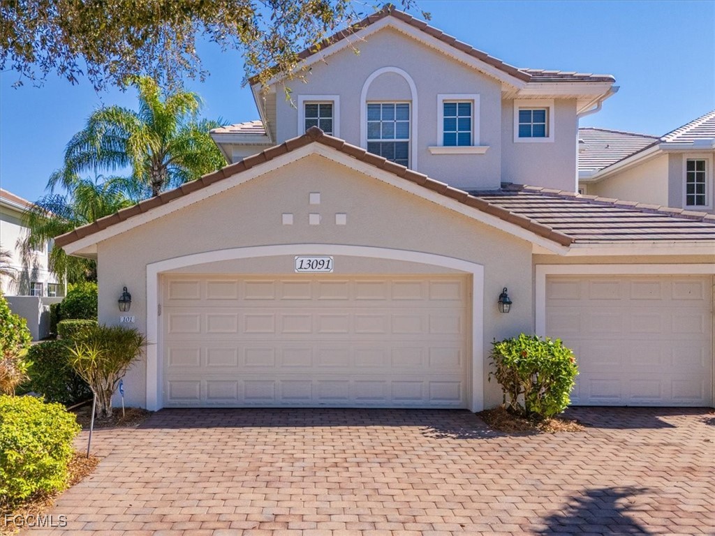 13091 Pebblebrook Ridge Court, Unit 101 Fort Myers, FL 33905 - Photo 30 of 39 a front view of a house with a yard