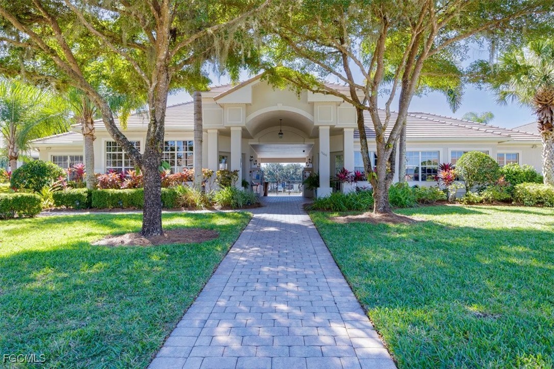 13091 Pebblebrook Ridge Court, Unit 101 Fort Myers, FL 33905 - Photo 31 of 39 a front view of a house with garden and trees