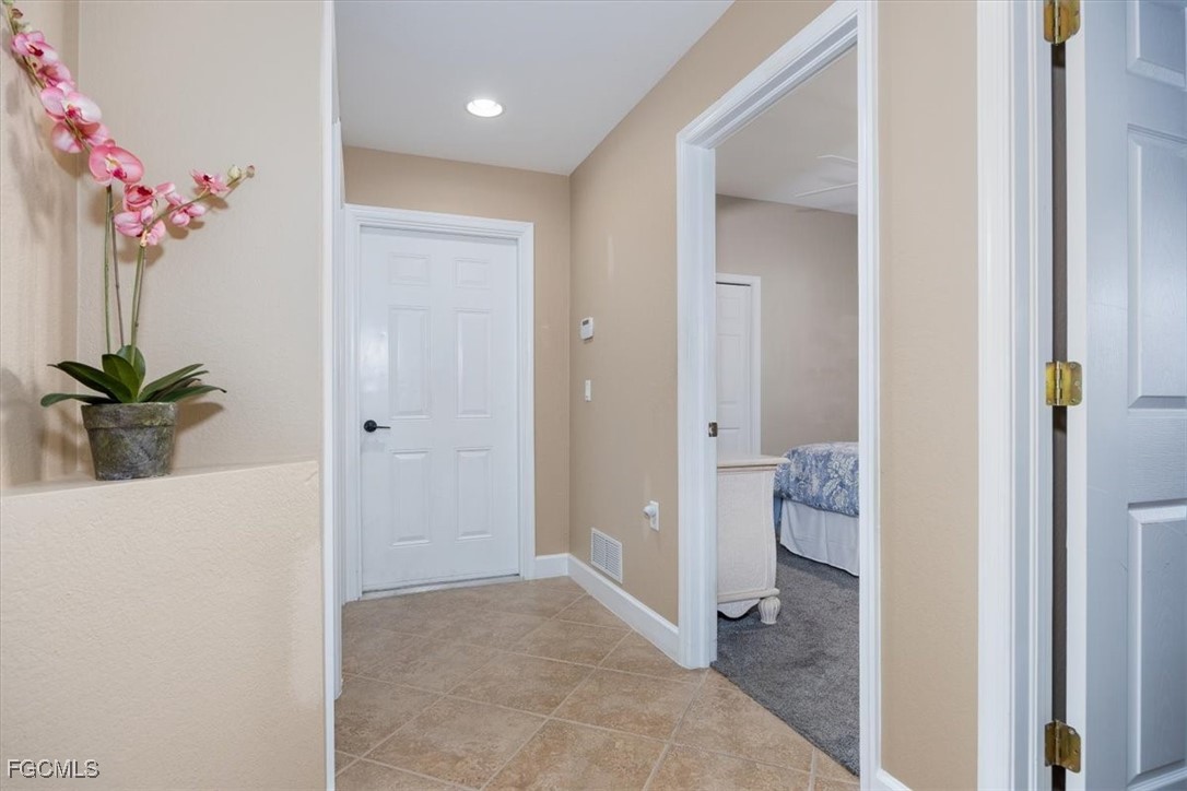 13091 Pebblebrook Ridge Court, Unit 101 Fort Myers, FL 33905 - Photo 4 of 39 a view of a bathroom from a hallway