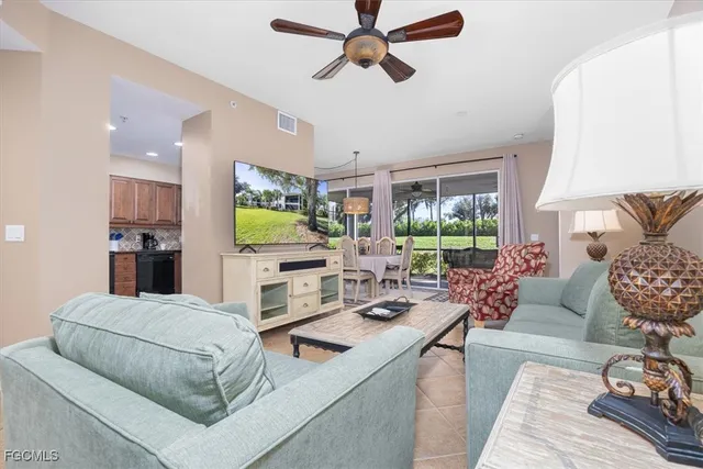 a living room with furniture fireplace and a large window