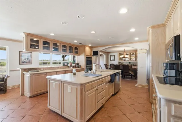 a kitchen with stainless steel appliances granite countertop a sink and a refrigerator