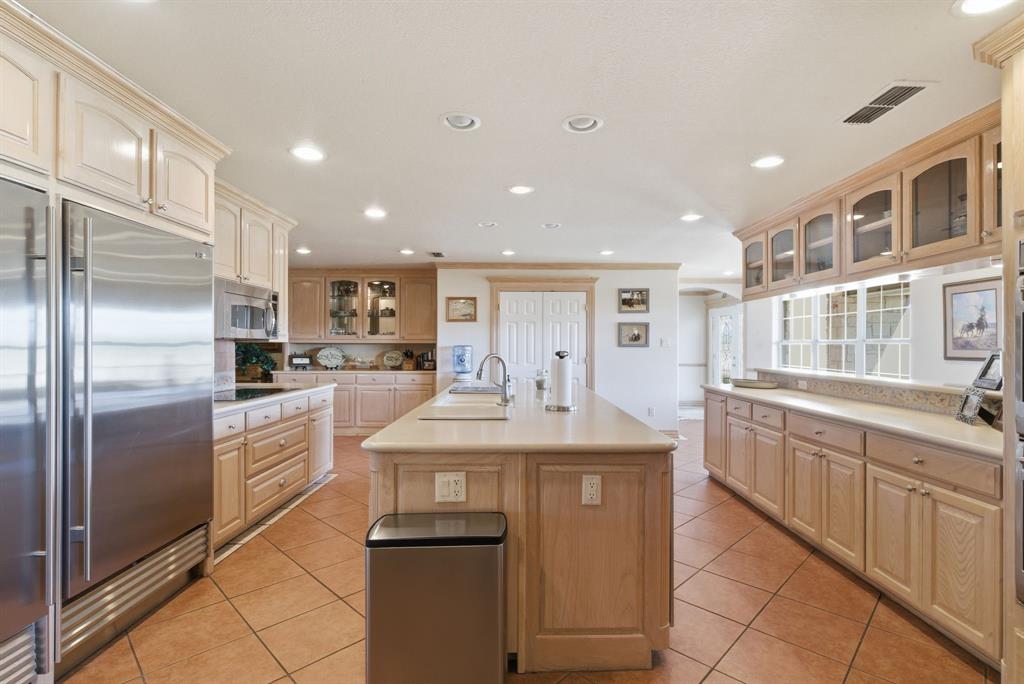 2691 North Fm Road 51 Springtown, TX 76082 - Photo 14 of 40 a kitchen with stainless steel appliances granite countertop a refrigerator and a stove top oven