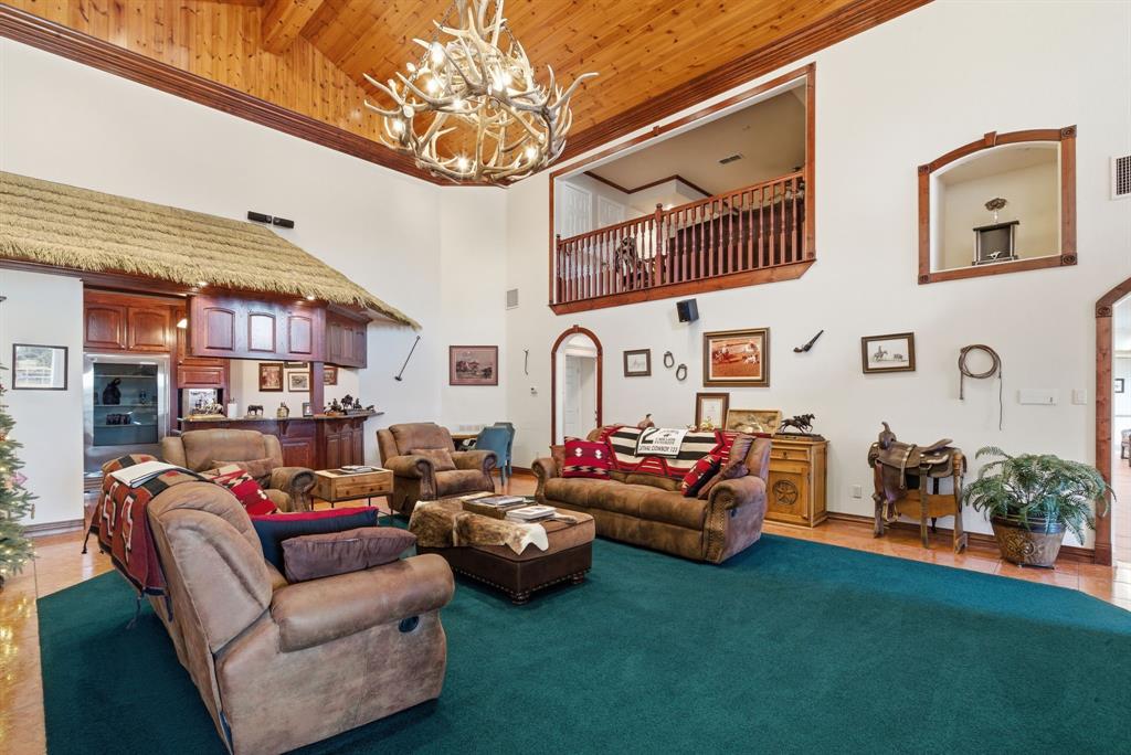 2691 North Fm Road 51 Springtown, TX 76082 - Photo 9 of 40 a living room with furniture a fireplace and a chandelier