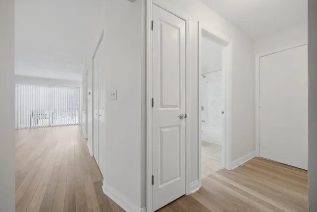 a view of a hallway with wooden floor