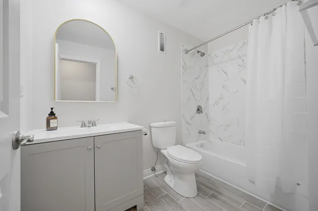 a bathroom with a toilet sink and shower