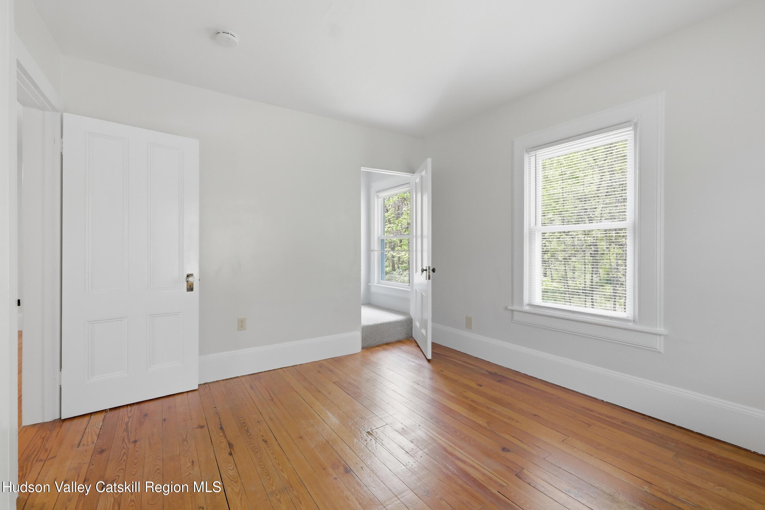 294 Kyserike Road Accord, NY 12404 - Photo 26 of 46 a view of an empty room with wooden floor and a window