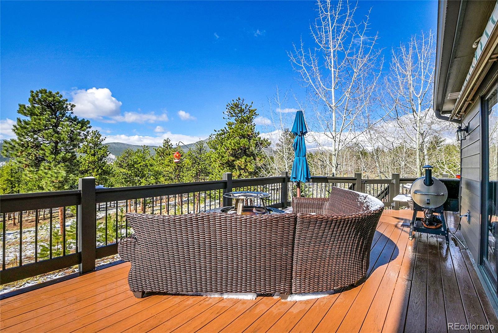 1567 Tapadero Road Bailey, CO 80421 - Photo 12 of 26 a view of balcony with wooden floor and outdoor seating